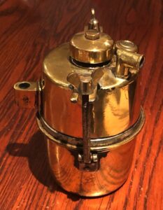 Very early motorcycle brass Carbide Acetylene gas generator. Vintage, veteran, pioneer and antique motorcycle acetylene gas powered carbide generator accessory